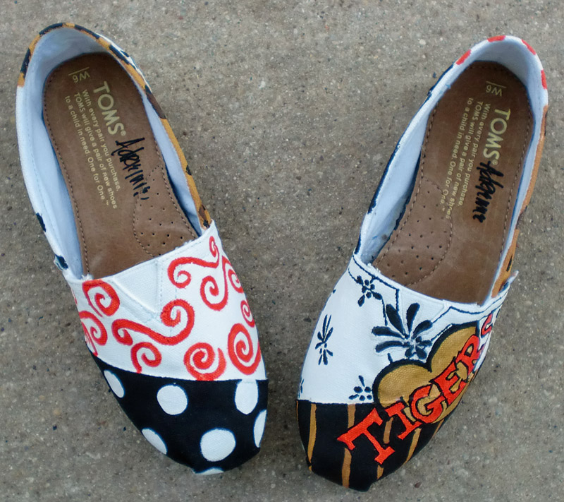 Orange, gorld, black and white designs painted on cheer toms Cheer Team spirit toms with design