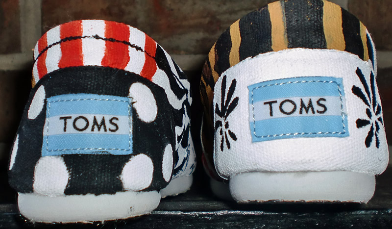 Orange, gold, black and white designs painted on cheer toms Cheer Team spirit toms with design