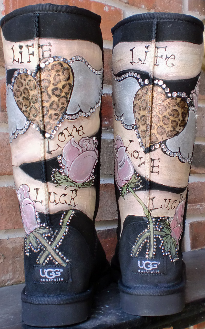 vintage tattoo design painted on uggs with banner of live laugh luck and personalized with name or intial hearts with wings leopard print in gold, blush pink, cream colors