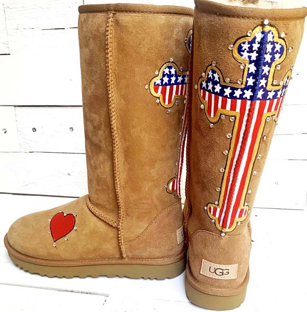 Custom painted UGG boots designed with a cross with the american flag filling in design and complete with crystalls outlining