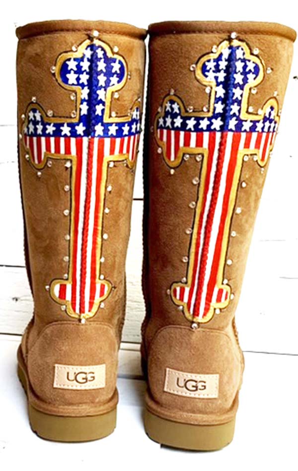 chestnut colored UGG boots with hand painted american flag designed cross on the back.