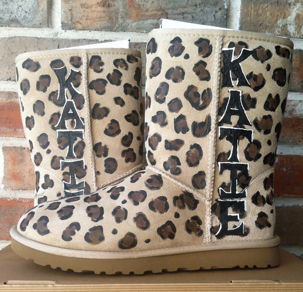 a pair of ugg boots that are sand colored with leopard print painted all over and personalized with your name down the side