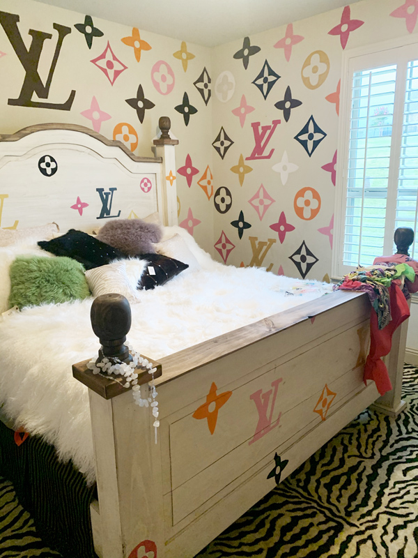 a mural of the Louis Vuitton logo pattern painted on walls in a bedroom