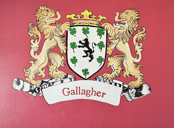 mural of the gallagher family crest painted on a red wall