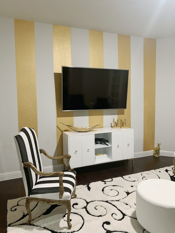 Mural of Metallic Gold stripes painted on a white wall