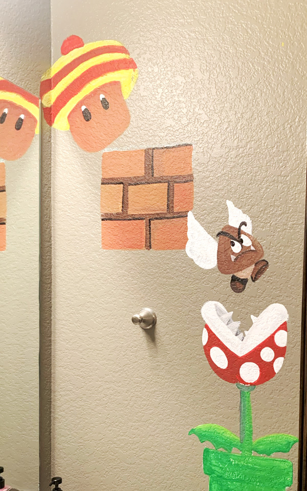 mural of mario brothers video game elements on a bedroom wall