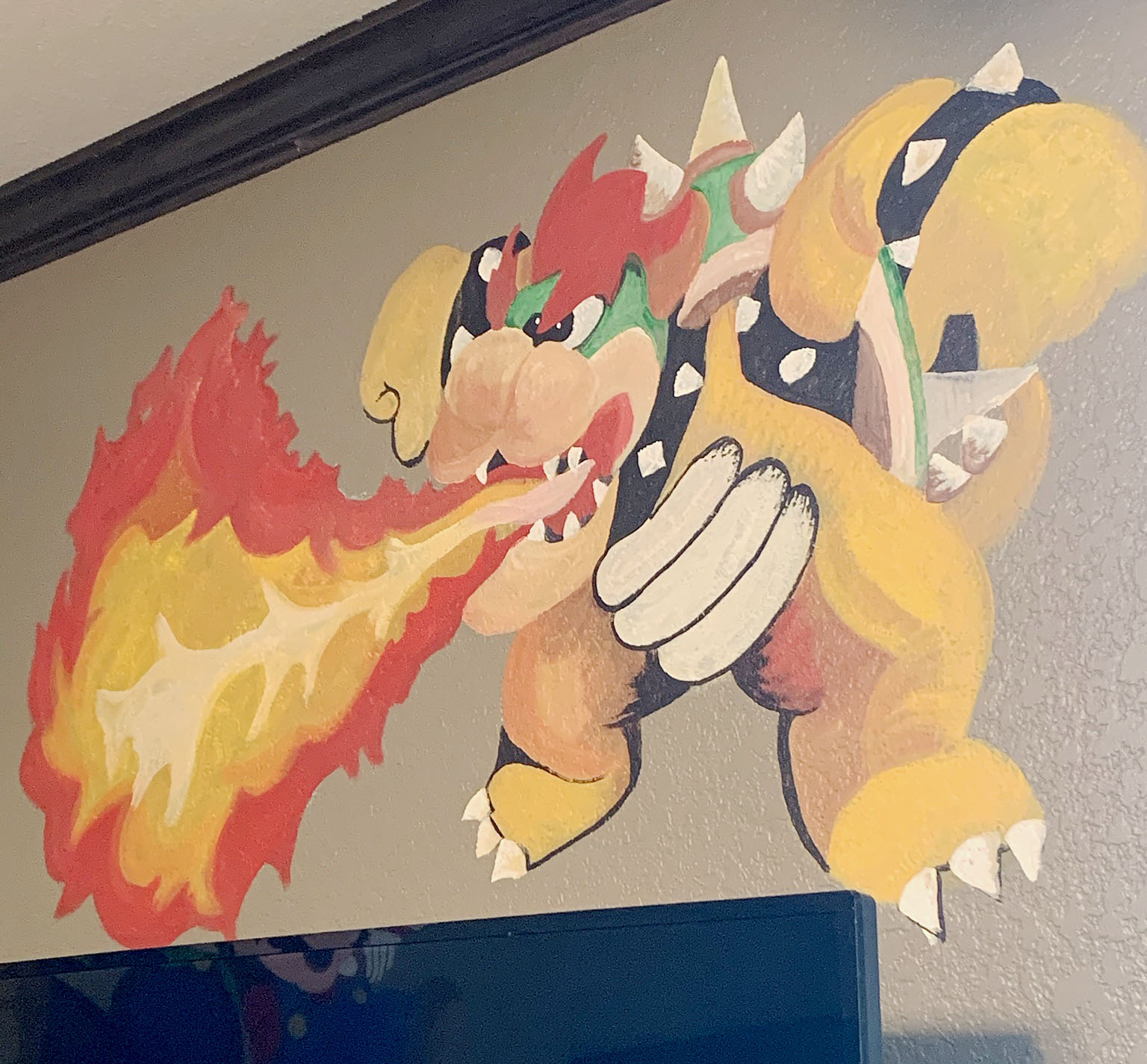 Painted mural of Mario Brothers video game on a wall in a boys bedroom
