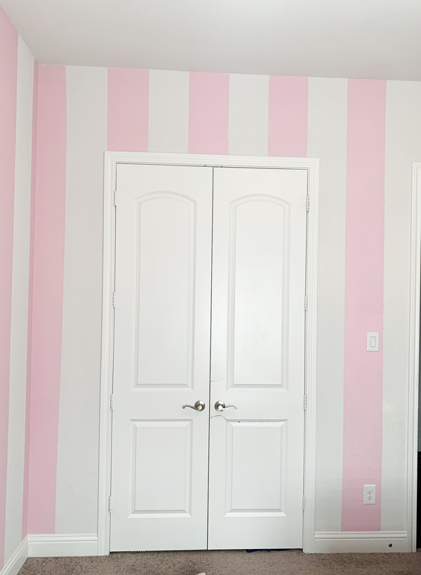 Mural of pink and white stripes in a nursery