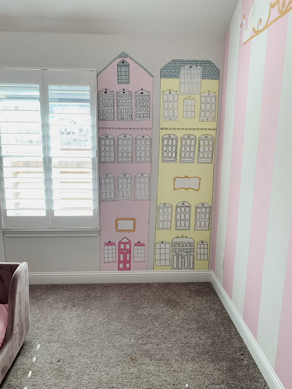 mural of apartment buildings atelier choux style in a girls nursery bedroom