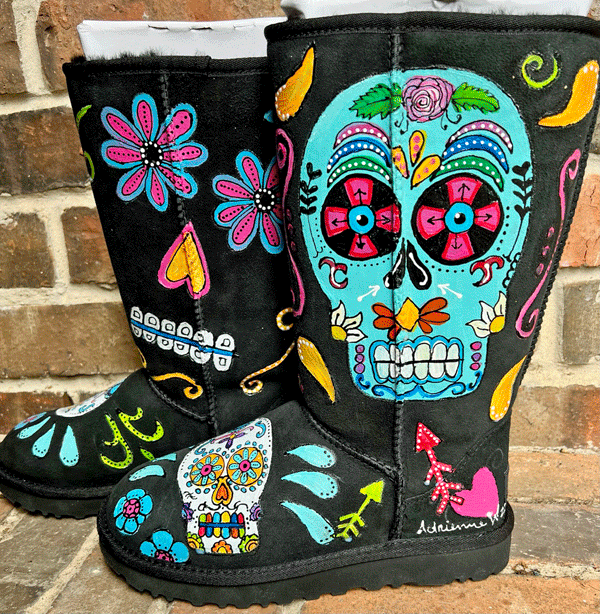 both sides of ugg boots with sugar skulls in a rainbow of colors hand painted on black uggs